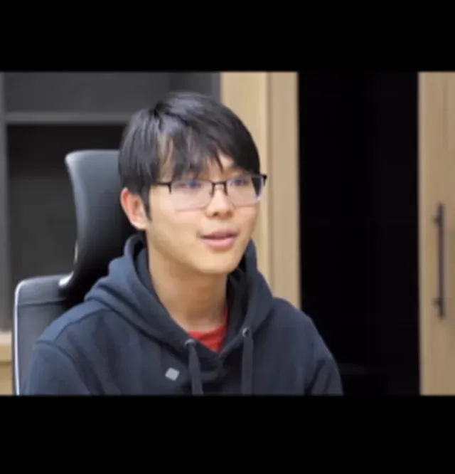 Young person wearing glasses in office setting