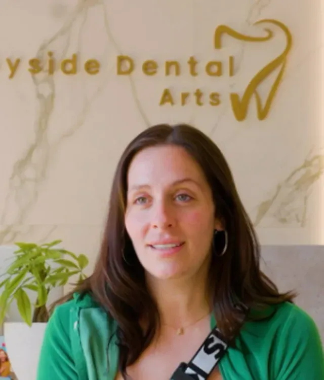 Bayside Dental Arts team member in green scrubs